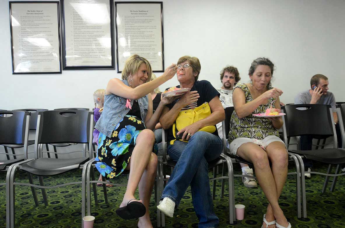 Stephanie, left, feeds her grandmother, Charlotte, a bite of cake as her mom, Tammy, eats at Stephanie's baby shower in Dalton, Ga.