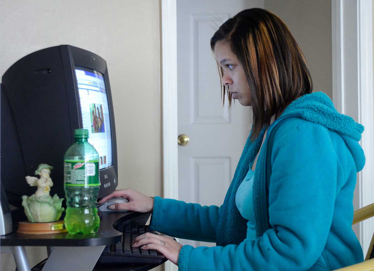 Dominique checks Facebook on the computer in the Carter Hope Center.