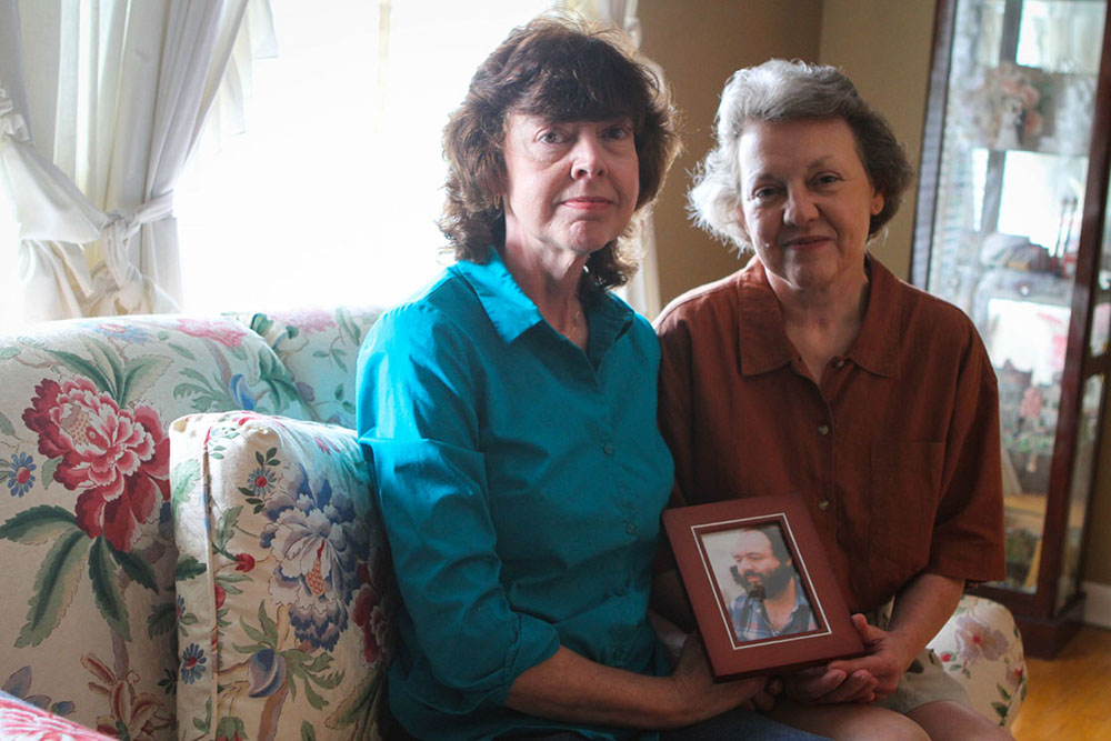 Gloria and Pam pose with their favorite photograph of Bubba. Its usual resting space is on a high shelf in Gloria's living room, looking out on everyone who enters.
