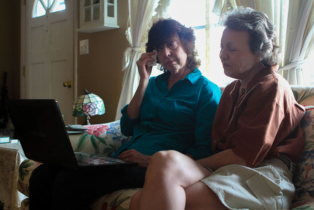 Gloria, left, and Pam become emotional looking through old photos of Bubba and the family.