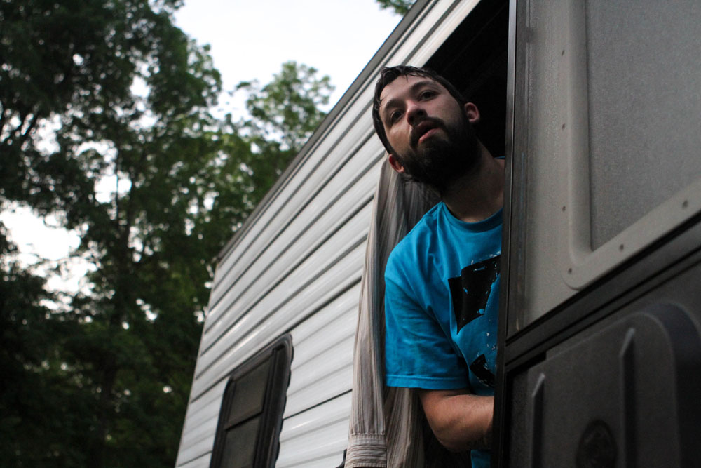 Ryan looks out of the camper where he stays with his father and Larae. Between the partial paralysis and seizures Ryan now navigates due to his brain damage, finding a job has proved to be impossible.