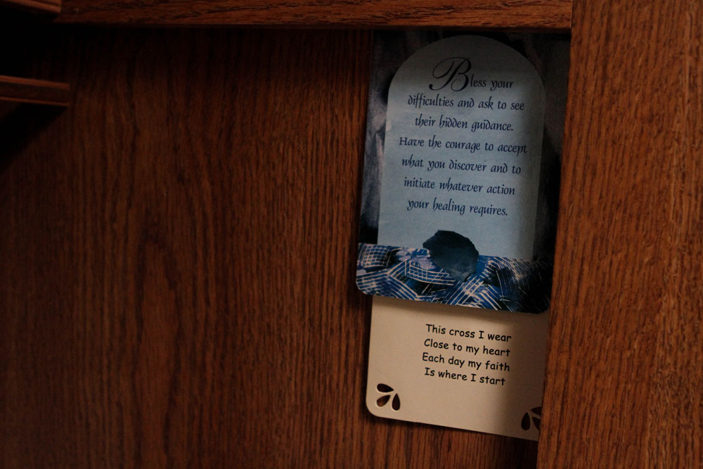Prayer cards sit wedged up on the wall in the bedroom of the camper where Ryan and Larae sleep.